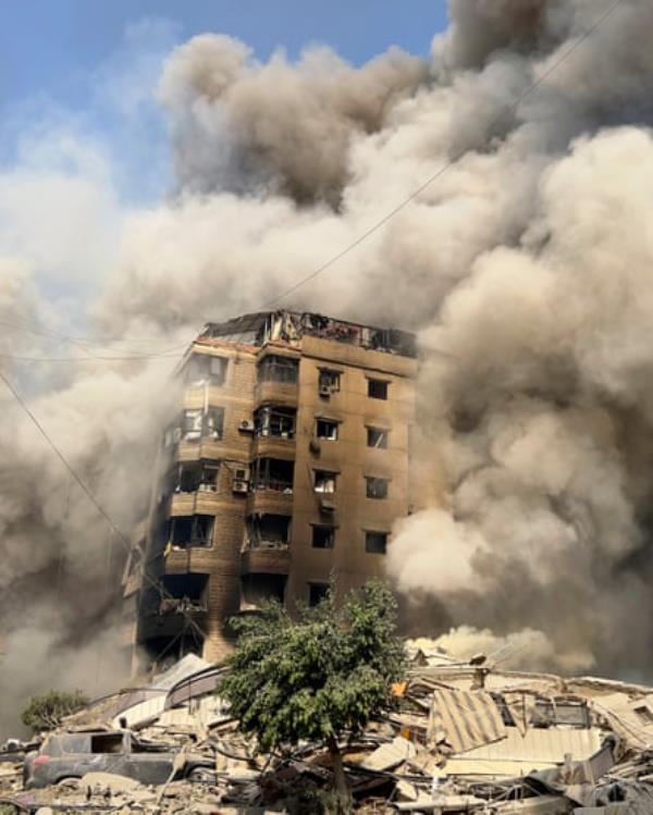 Smoke engulfs a collapsing building in Beirut’s southern suburbs.